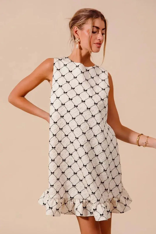 SO ME Texture Bow sleeveless mini dress with black and white bow print and ruffle hem