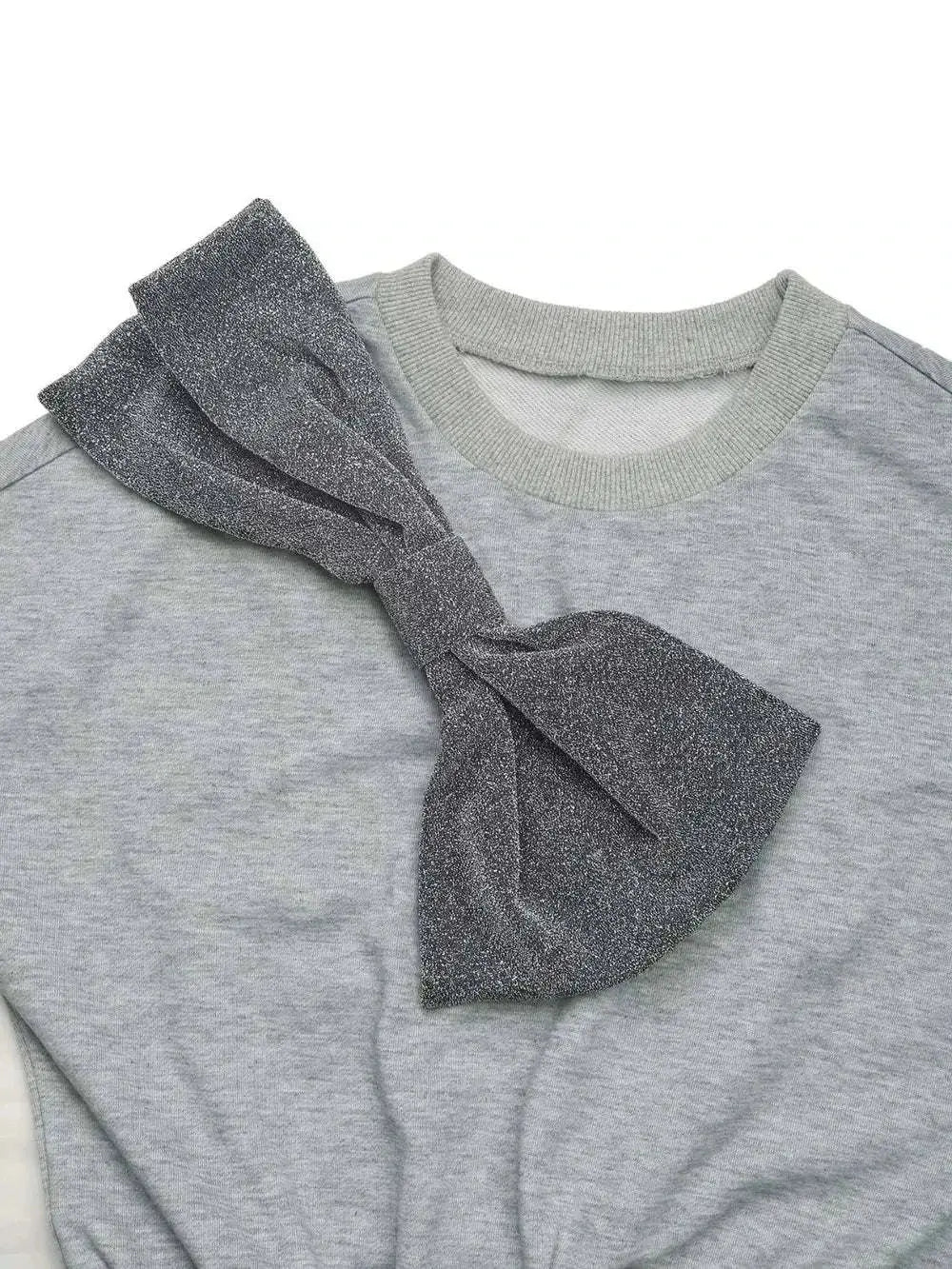 Close-up of grey Perfee Bow Mini Dress with large glittery bow and dropped shoulder design